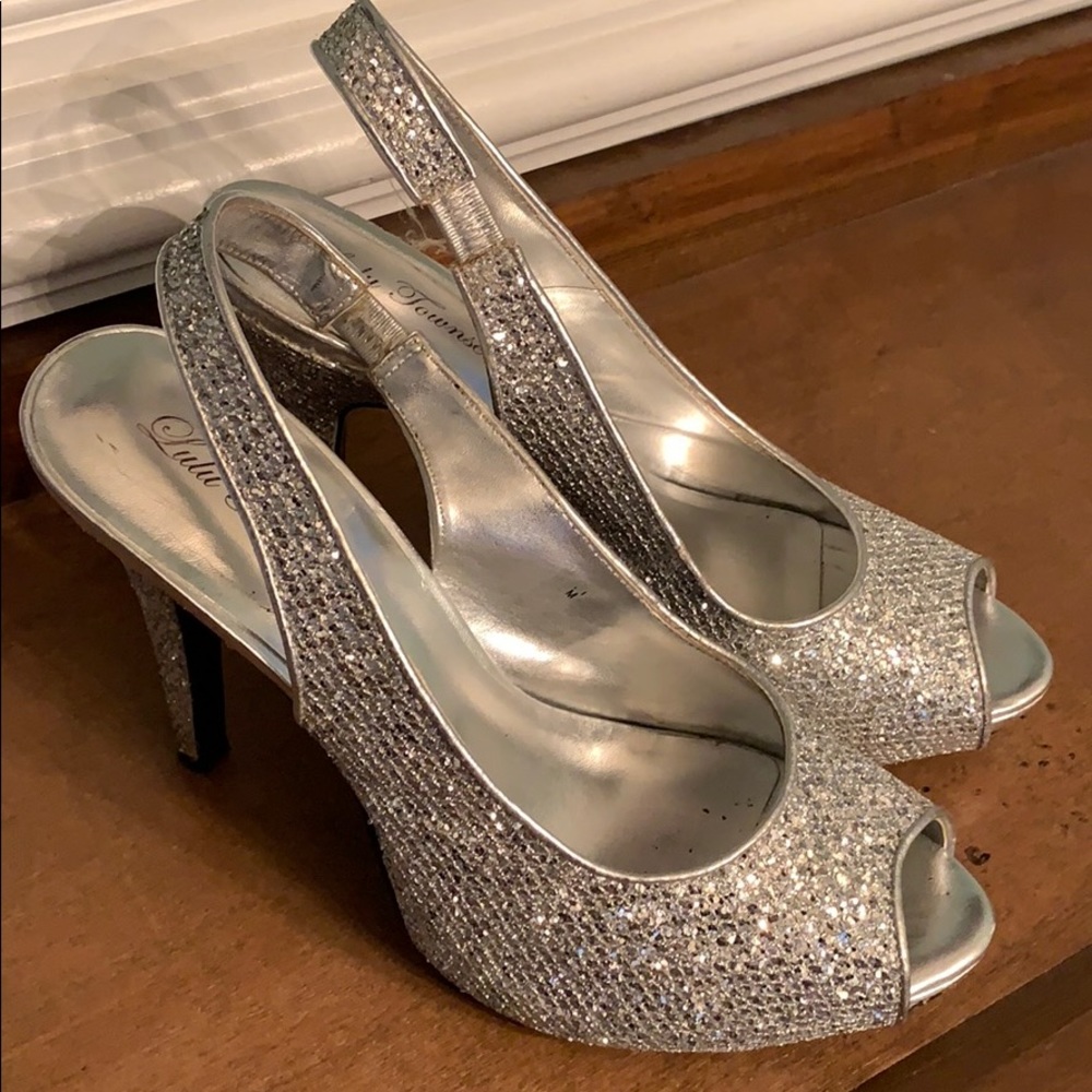 Sparkling silver open toe platform heels.